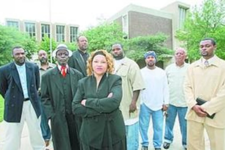 Parent Arenda Bethel (center) at Ada H. Lewis Middle School with other concerned residents, contractors and engineers.