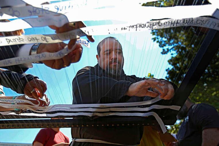 Brother Michael Meza, a Capuchin Franciscan, weaves messages of struggle into a piece of art to be displayed for Pope Francis in Philadelphia. The city's delegation landed in Rome on Monday to plan for the visit. Stories, A4.
