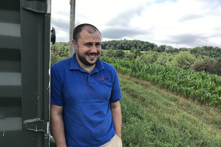 Jeffrey Houser, 38, on the hill behind his office in rural Indiana County and next to one of his antennas.
