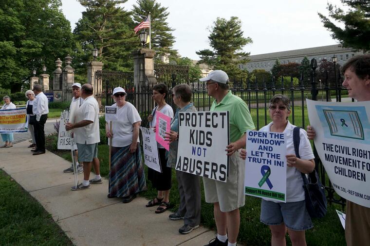 Demonstrators gather at St. Charles Borromeo Seminary in Wynnewood in support of a Pennsylvania measure to lift the civil statute of limitations in many child sex-abuse cases. Opponents warn such a change could be ruinous.