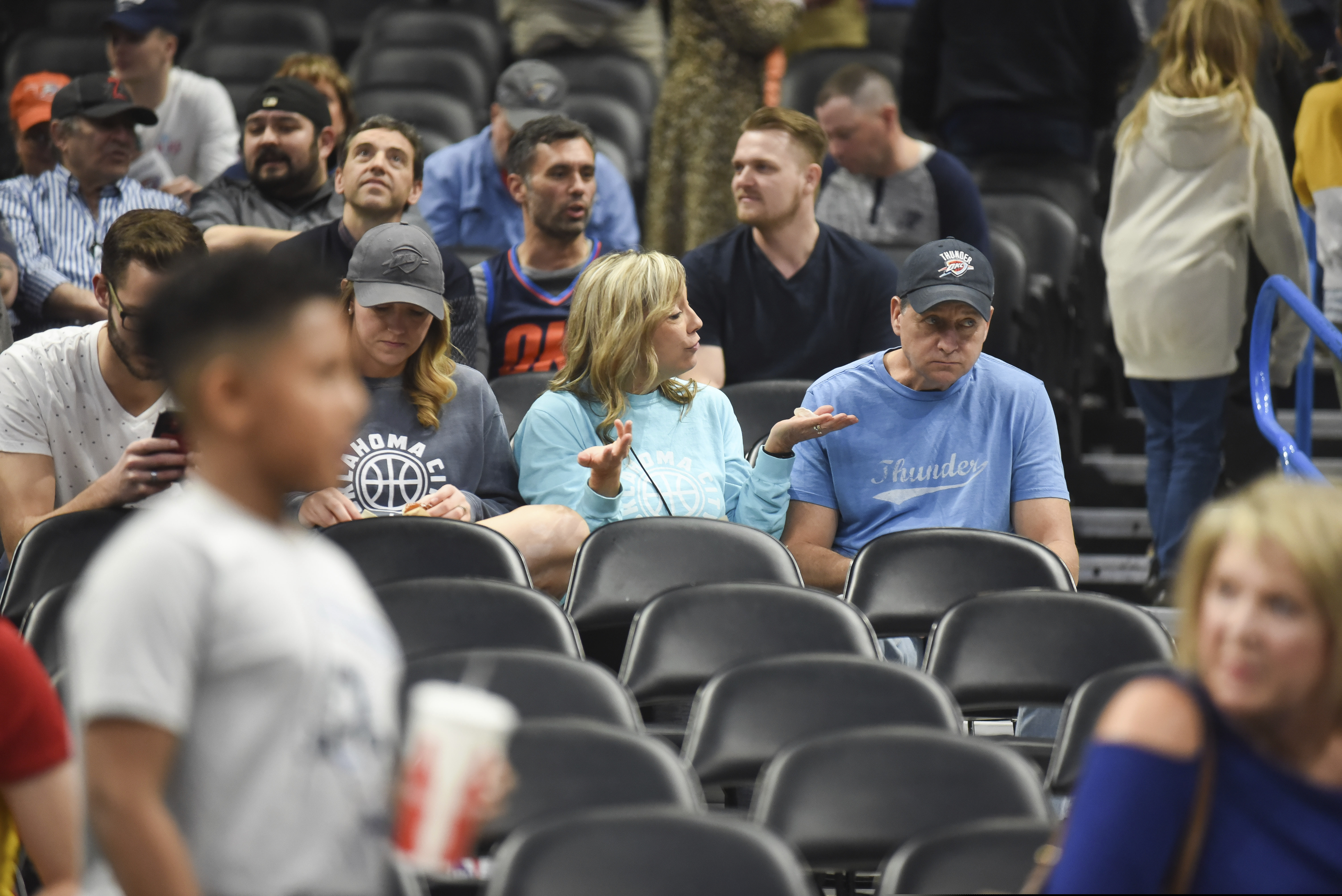 Basketball fans react after it is announced that an NBA basketball game between Oklahoma City Thunder and Utah Jazz in Oklahoma City has been postponed on Wednesday.
