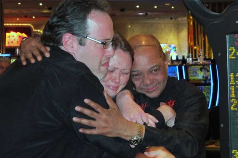 Dealers at the Atlantic Club share a tearful hug just after the Atlantic City casino shut its doors early Monday. The casino hotel was sold at a bankruptcy auction in December to two competitors, who will strip it for parts. (Wayne Parry / Associated Press)