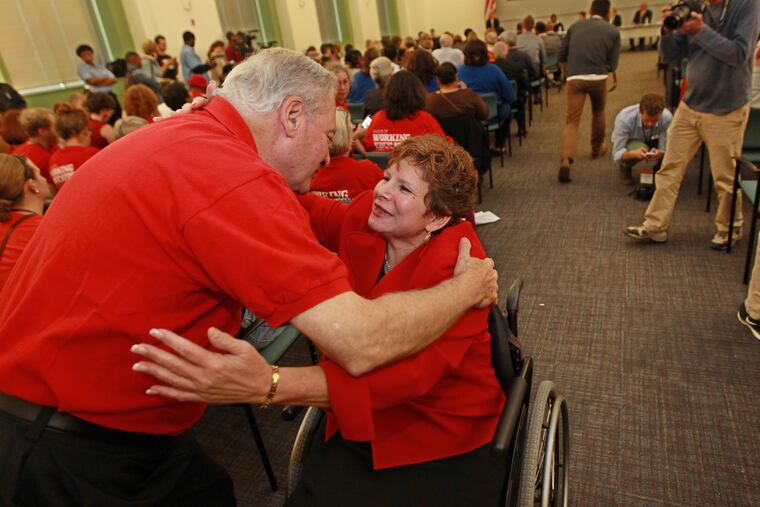 In this Inquirer file photo, State Senator Tina Tartaglione, right, is hugged by Ted Kirsch, Pennsylvania Teachers union president, left, after Tartaglione said she would introduce legislation to abolish the SRC.