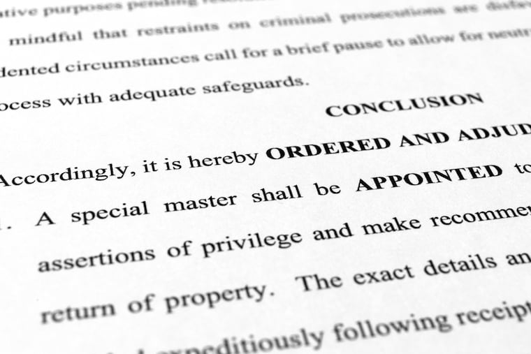 A page from the order granting a request by former President Donald Trump's legal team to appoint a special master to review documents seized by the FBI during a search of his Mar-a-Lago estate is photographed Monday, Sept. 5, 2022.