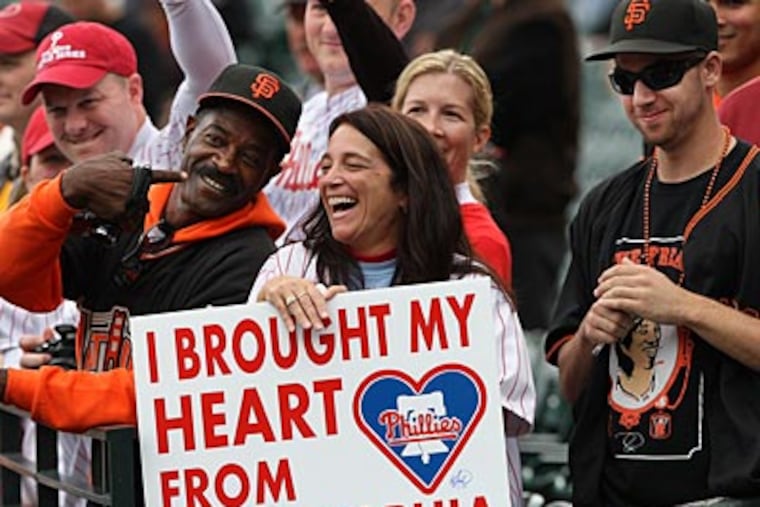 West Deptford's Margaret Gardner (center) shows her support for the Phillies between Giants fans. ( Michael Bryant / Staff Photographer )