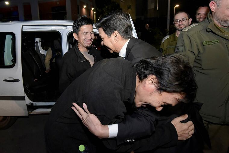 In this photo provided by Thailand's Foreign Ministry, two newly-freed Thai hostages hug Thai Foreign Minister Parnpree Bahiddha-Nukara, center, at the Shamir Medical Center in Israel on Tuesday. Hamas freed several Thai nationals seized in the group's surprise attack on southern Israel the month before, releasing them alongside Israeli hostages under a cease-fire deal.