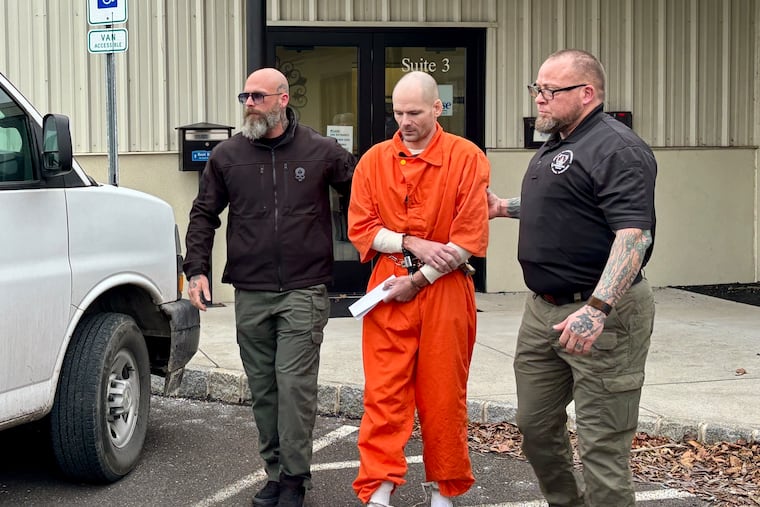Nathan Blose is escorted to a police vehicle Tuesday after his preliminary hearing on murder charges at a district court in Harleysville.