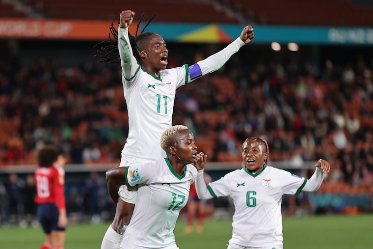 Zambia's Racheal Kundananji carries teammate Barbra Banda as Mary Wilombe, right, runs in as they celebrate their third goal in their 3-1 victory over Costa Rica on Monday.