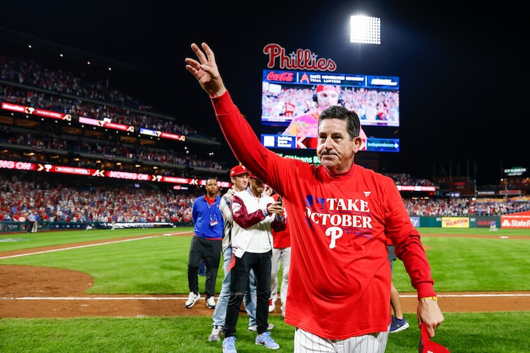Phillies manager Rob Thomson waves to fans after a 2023 wild-card win. He was fired Tuesday.