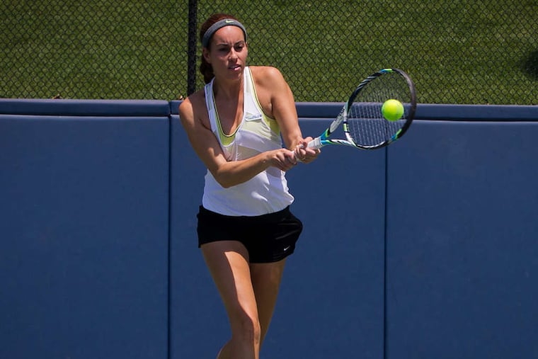 Alexandra Riley, known as "Xan," practices at Penn. Usually the tennis pro is traveling the world, by herself, to compete in minor-league events as she tries to raise her profile. She and her father text daily.