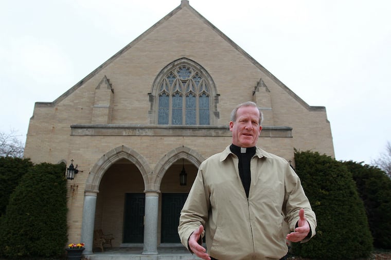 The Rev. Thomas M. Higgins in front of Holy Innocents in Juniata Park, sole survivor of a five-way merger. It left him in charge of 22 buildings that had to be sold or rented. (Michael Bryant/Staff Photographer)