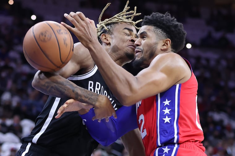 Tobias Harris, right, of the Sixers collides with Nic Clayton of the Nets during the 1st half of the Sixers home opener at the Wells Fargo Center on Oct. 22, 2021.