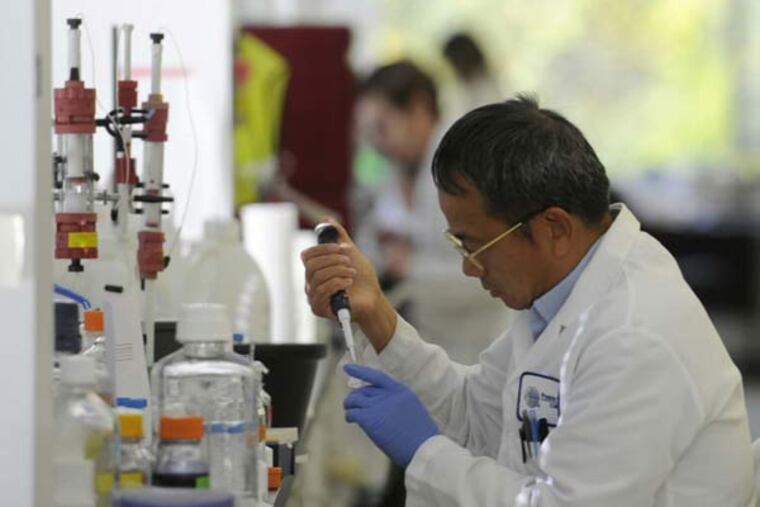 Protein Sciences scientist Keyang Wang works in the company's labratory in Meriden, Conn. The company is working to create a vaccine for the Ebola virus. (Michael McAndrews/Hartford Courant/TNS)