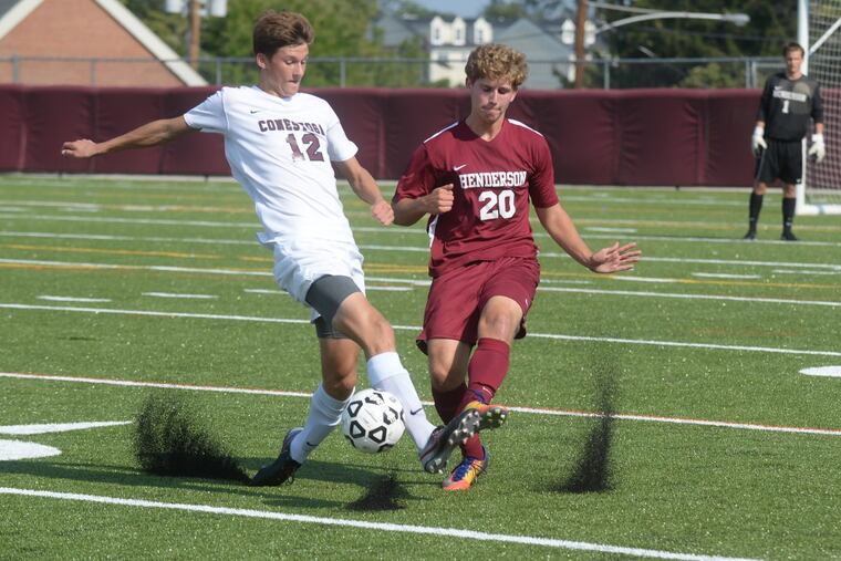 Chris Donovan of Conestoga (left) makes a move past Chris Roberts of West Chester Henderson.