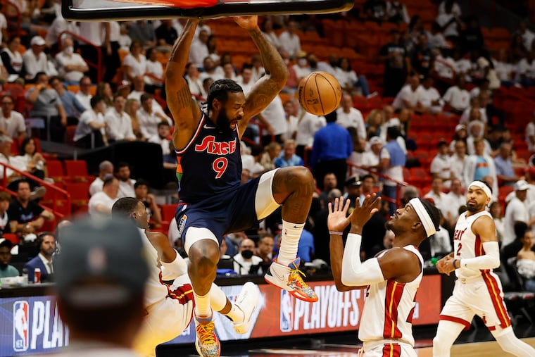 Sixers center DeAndre Jordan dunks the basketball past Miami Heat forward Jimmy Butler during the first quarter in game one of the second-round Eastern Conference playoffs on Monday, May 2, 2022 in Miami.