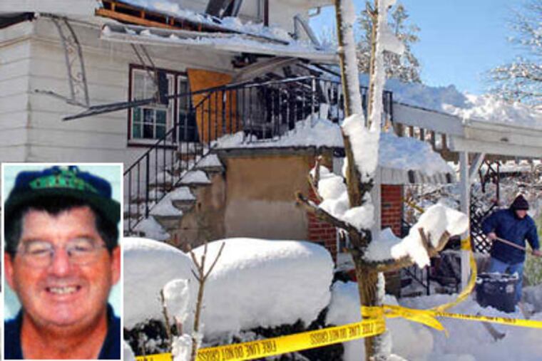 Mark Boles shovels a path from the house where his brother, James, died after a roof structure, heavy with snow, fell atop him. (Tom Gralish / Staff Photographer)