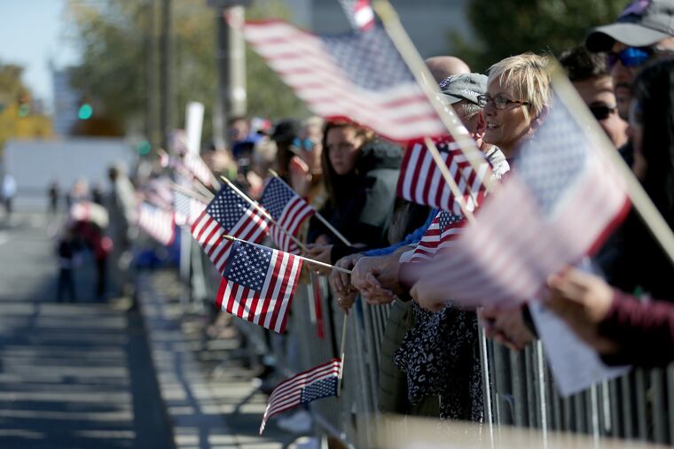 The crowd waves American flag during the Veterans Day parade at 6th and Market Streets in Philadelphia, PA on November 4, 2018. DAVID MAIALETTI / Staff Photographer