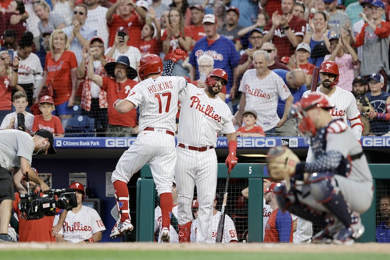 Rhys Hoskins and Darick Hall celebrate Hoskins' solo home run in the fourth inning.