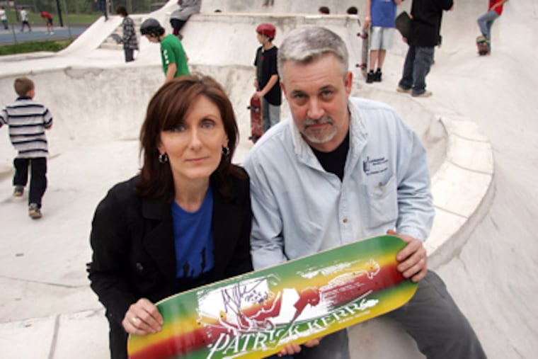 Liz and Pearse Kerr with a skateboard bearing son Patrick’s name at the skate park in Roslyn that he had been raising money to build when he died in 2002. (David Swanson / Staff Photographer)