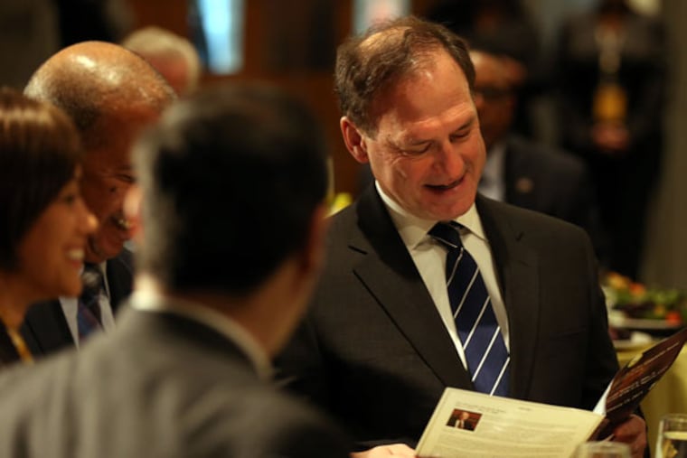 Supreme Court associate Justice Samuel A. Alito Jr. looks over the program before accept a citizenship award during a luncheon at Community College of Philadelphia on Jan. 15, 2015. ( DAVID MAIALETTI / Staff Photographer )