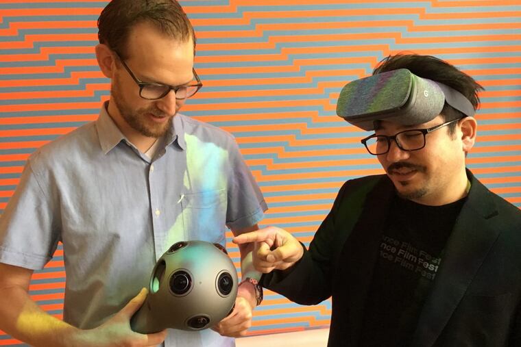 Kevin Ritchie (left) and Ricardo Rivera show off the multi-lens Nokia VR camera and Google eyewear that Klip Collective used to shoot and view their immersive training day video for Honeygrow. (JONATHAN TAKIFF/Staff)