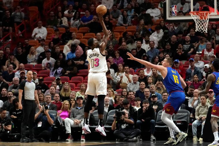 Miami Heat center Bam Adebayo goes to the basket as Denver's Nikola Jokic defends on Feb. 13. The two will face off in the NBA Finals starting Thursday.