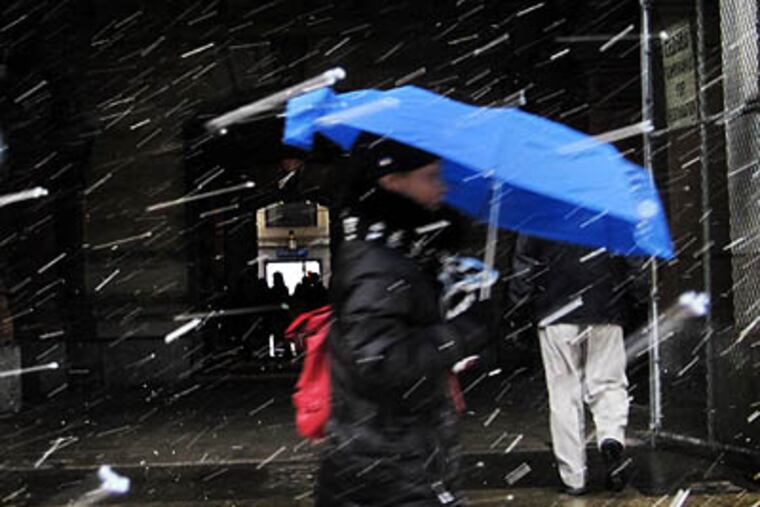 File photo: Wet snow falls in streaks at City Hall in Philadelphia during an earlier storm.