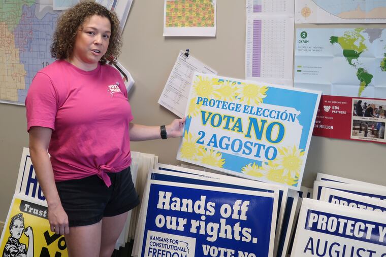 Jessica Porter, communications chair for the Shawnee County, Kansas, Democratic Party, discusses a sign in Spanish urging voters to oppose a proposed amendment to the Kansas Constitution to allow legislators to further restrict or ban abortion, Friday, July 15, 2022, in Topeka, Kansas.