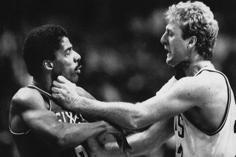 Julius Erving, left, and Larry Bird square off during a second half fight at the Boston Garden in 1984.
