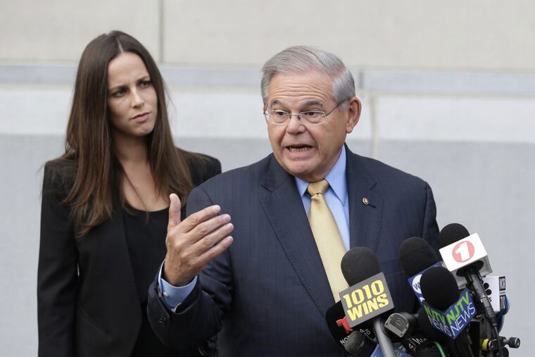 While his daughter Alicia Menendez looks on, Sen. Bob Menendez talk to reporters as he arrives to court in Newark, N.J., Wednesday, Sept. 6, 2017. (AP Photo/Seth Wenig)