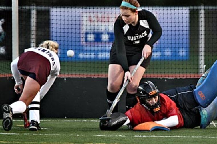 Eastern's Cori Allen (left) scores the first goal on Bishop Eustace goalie Alex Pecora. (David M Warren/Staff Photographer)
