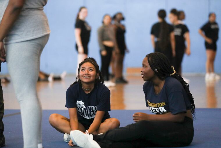 Adamaris Lopez (left) sits during cheer practice at George Washington High School in September.