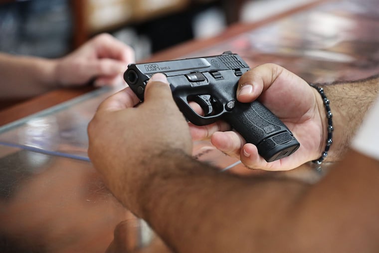 A customer looks at a handgun at the Kissimmee, Florida, location of The Armories on Dec. 31, 2020.