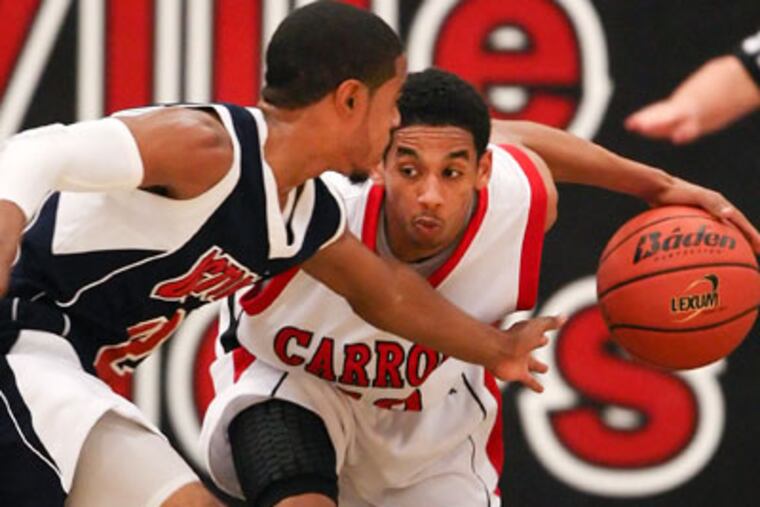 Carroll's Yosef Yacob drives around Octorara's Charles Cooper. (Steven M. Falk / Staff Photographer)