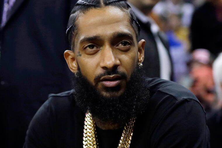 Rapper Nipsey Hussle attends an NBA basketball game in 2018. Eric R. Holder Jr., who was convicted last year of fatally shooting Hussle in 2019 and was sentenced to 60 years in prison.