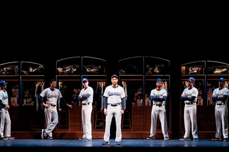 This image released by Polk & Co. shows Jesse Williams (center) during a performance of the Broadway revival of the baseball-themed "Take Me Out," in New York.