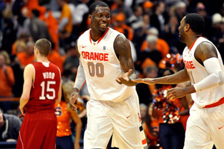 Rick Jackson (center) demonstrated major improvement in each of his four seasons at Syracuse. (Kevin Rivoli/AP file photo)