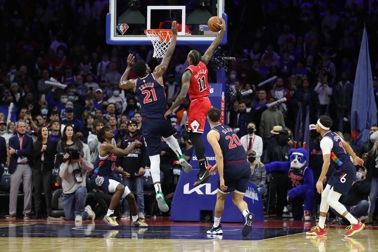 Joel Embiid of the Sixers goes up to block a shot by DeMar DeRozan of the Bulls in the final seconds of their game at the Wells Fargo Center on Wednesday.