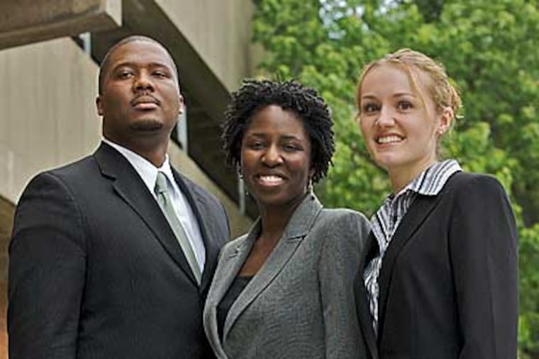 Standing outside the Drexel Law school on Market Strret in are Raheem Watson, Elizabeth Nicolas, and Lindsey Hoban. They are among Drexel University's first law school graduates.( John Costello /Staff Photographer )