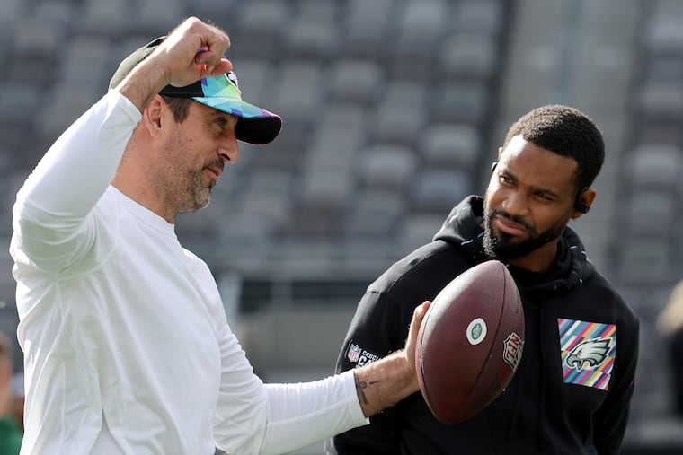 New York Jets quarterback Aaron Rodgers (left) and Eagles Philadelphia Eagles cornerback Darius Slay (right) talk before the Eagles play the Jets at MetLife Stadium East Rutherford, N.J. on Sunday, Oct. 15, 2023. Both players are inactive due to injuries.