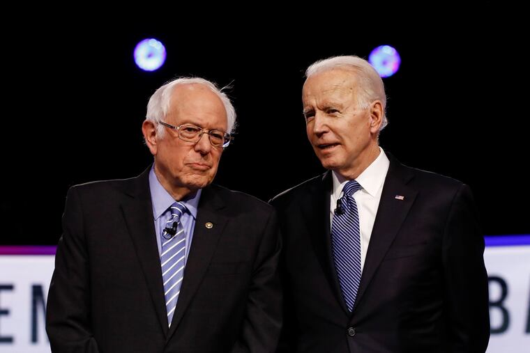 Bernie Sanders, left, and Joe Biden talking earlier this year before a Democratic presidential primary debate in Charleston, S.C.