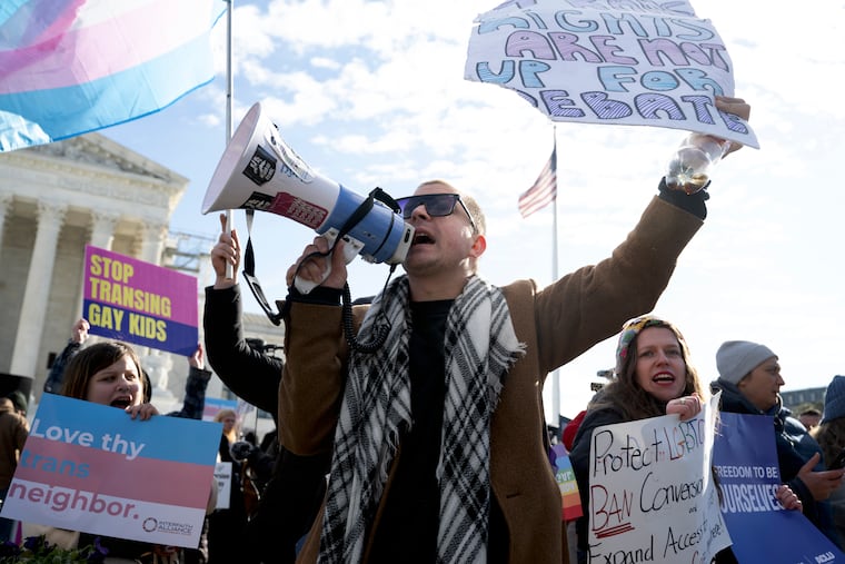 Trans rights activists and their opponents rally outside the Supreme Court in December 2024.