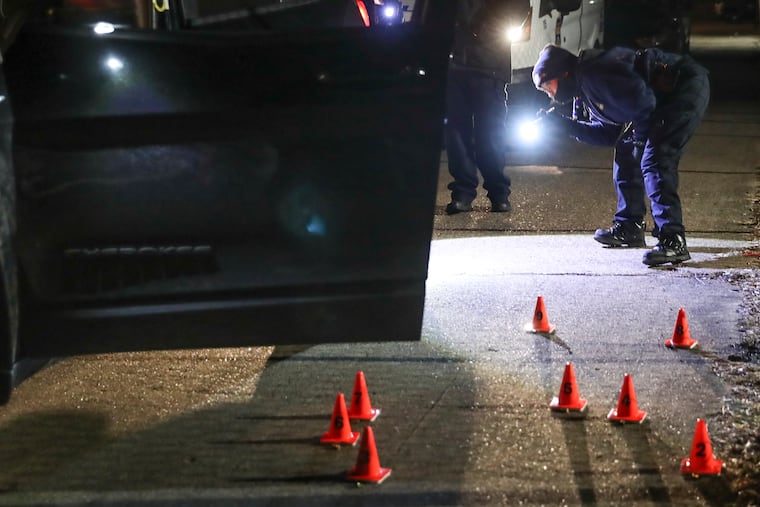 After shots were fired at police on Revere Street near Cottman Avenue, crime scene investigators look over the suspect's car and shell casings near the driver's-side door. A suspect was arrested and a gun was recovered. Thursday, Jan. 20, 2022.