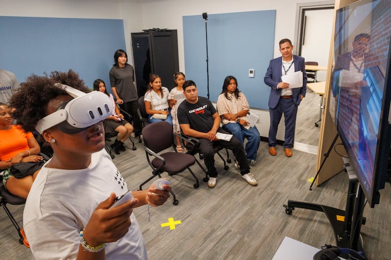 Jalen Carter, a student at School of the Future, makes his presentation in front of families of participants in the Academy at Penn program at the end of July. Standing by the door is Rich Mitchell, executive director of Academy at Penn. The program just held its first summer session.