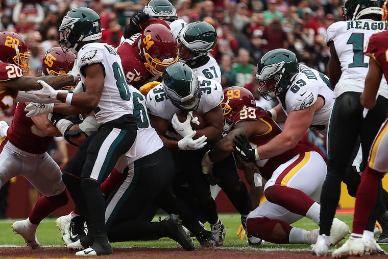 Philadelphia Eagles running back Boston Scott (center) scores a touchdown against Washington in the second quarter. The Philadelphia Eagles play the Washington Football Team in Landover, Md. on Sunday, Jan. 2, 2022.