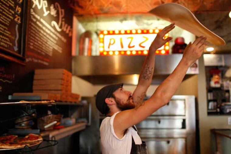 Tony Montagnaro throws a pizza at Pizza Brain. ( Michael S. Wirtz /
Staff Photographer )