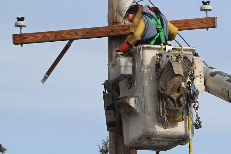 A Peco lineman repairs a utility pole in Blue Bell.