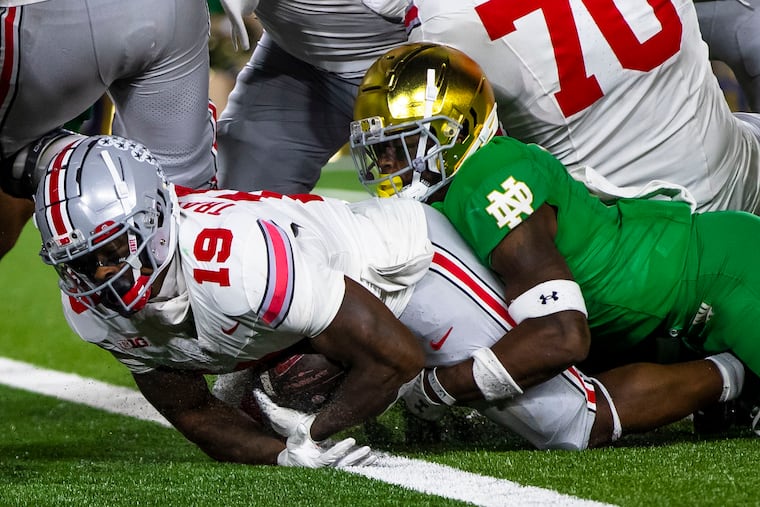 Ohio State running back Chip Trayanum scores the winning touchdown as Notre Dame safety DJ Brown (2) tries to stop him Saturday in South Bend, Ind.