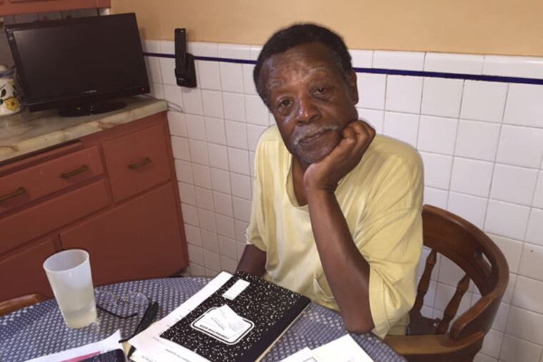 Ron Walker reviews his unpaid medical bills in his West Philly kitchen. He could pay them tomorrow if the Sheriff's Department would cut him the check he's owed for the sale of a house he owned. (RONNIE POLANECZKY/DAILY NEWS STAFF)