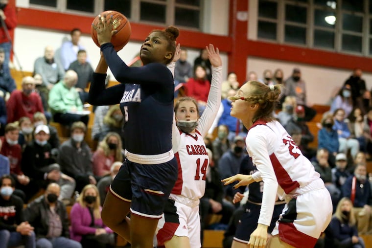 Cardinal O'Hara's Sydni Scott, left, who has a scholarship to Marshall, goes up for a shot against Archbishop Carroll's Grace O'Neill, right, on Feb. 1, 2022.
